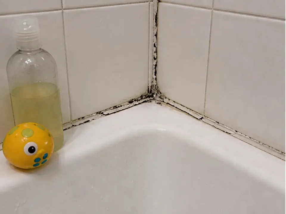 Tub corner rebuilt with silicone before