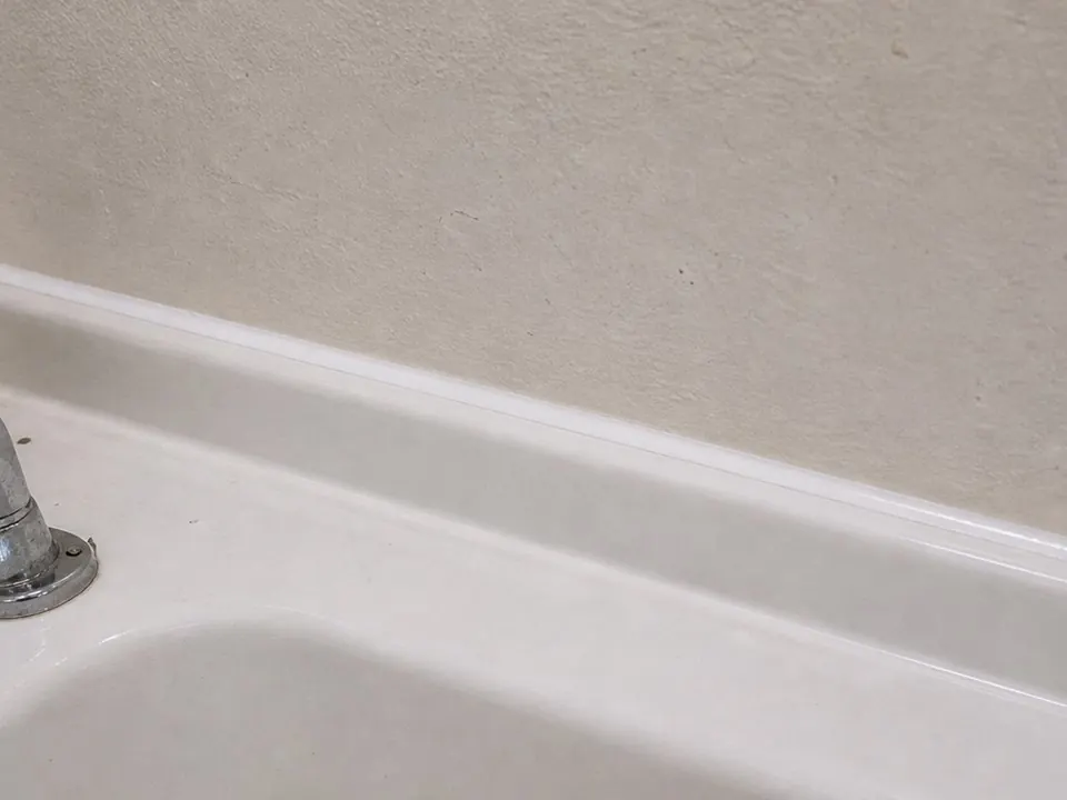 Sink back edge sealed after