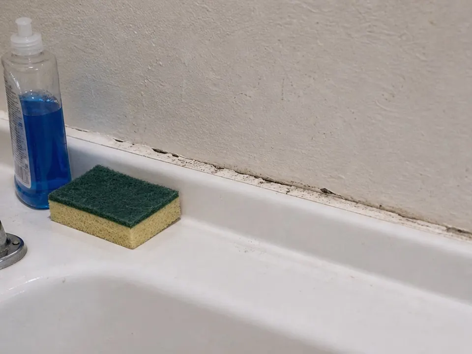 Sink back edge sealed before