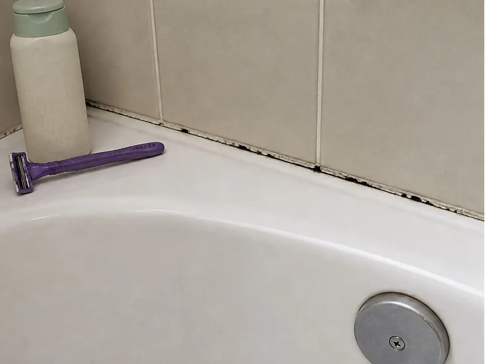 Old tub caulk removed before