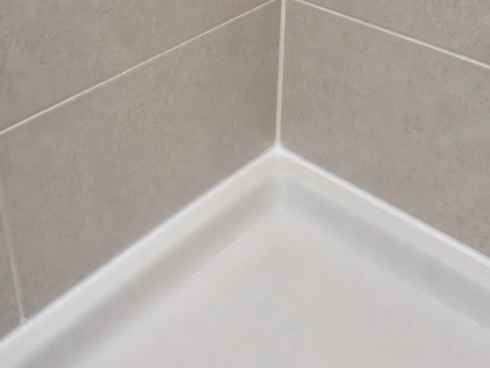 Shower pan corner sealed after