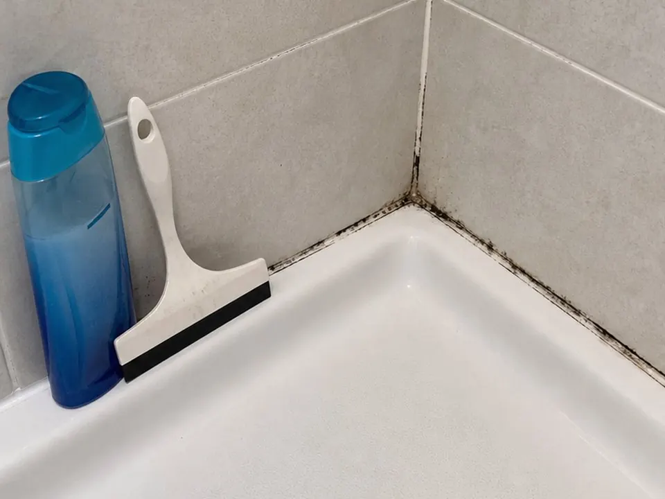 Shower pan corner sealed before