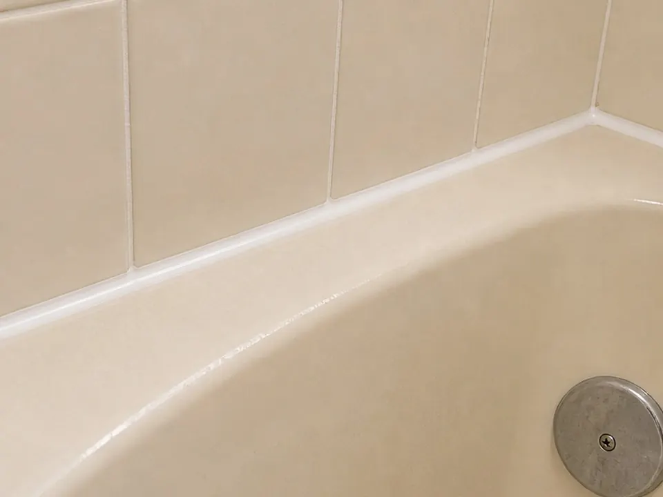 Almond tub caulk line after