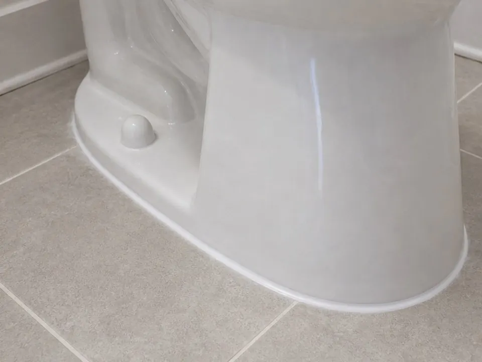Toilet base caulk after